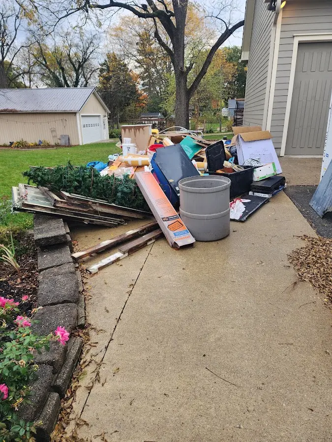 Dumpster being loaded with debris for 30 Yard Dumpster Rental in Oneida